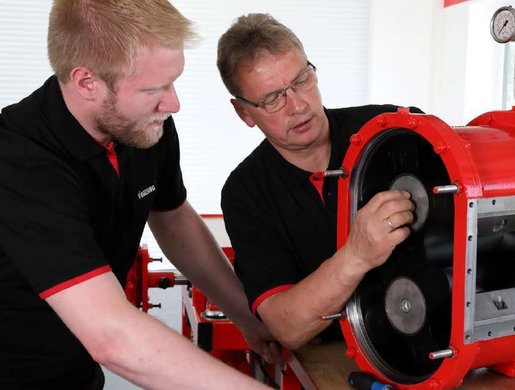 Two Vogelsang service mechanics working on a pump