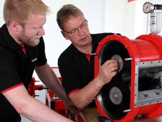 Two Vogelsang service mechanics working on a pump