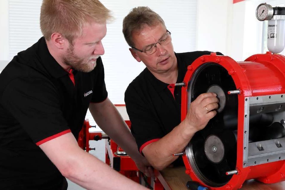 Two Vogelsang service mechanics working on a pump Two Vogelsang service mechanics working on a pump